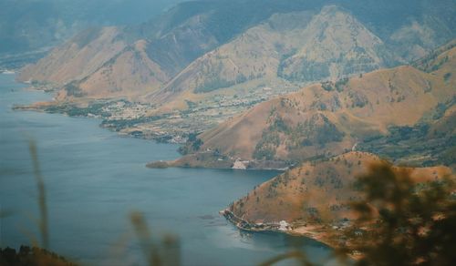 High angle view of lake amidst mountains against sky