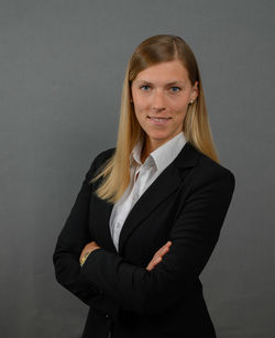 Portrait of a smiling young woman against gray background