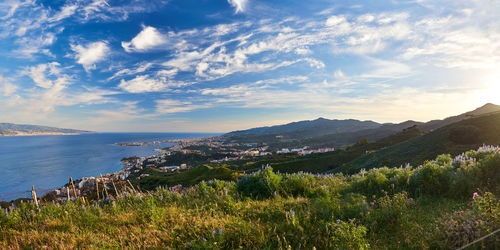 Scenic view of sea and mountains against sky