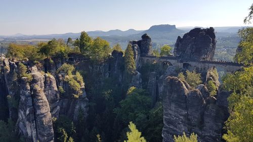 Scenic view of trees and mountains against sky