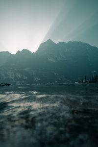 Scenic view of sea and mountain against sky