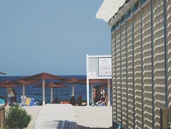 View of beach against clear blue sky