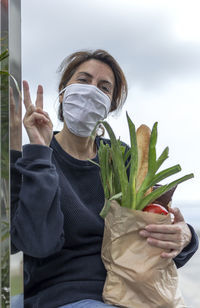 Portrait of person holding plant