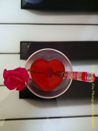 Close-up of red rose on table