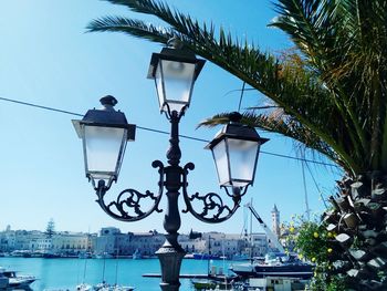 Low angle view of street light against blue sky