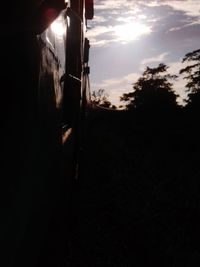 Close-up of train against sky at sunset