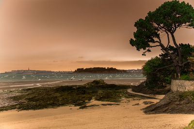Scenic view of beach against sky during sunset