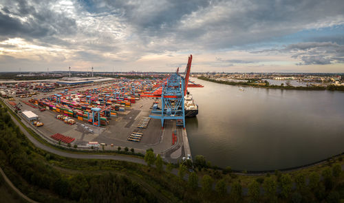 High angle view of river amidst city against sky