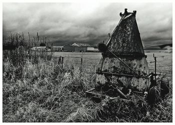 Abandoned built structure on field against sky