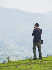 Rear view of man standing on mountain