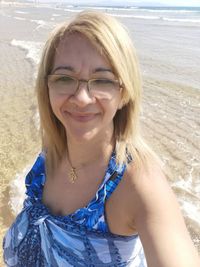 Portrait of smiling young woman on beach