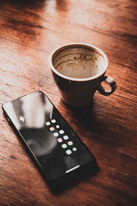 Close-up of coffee  and a cellphone on table