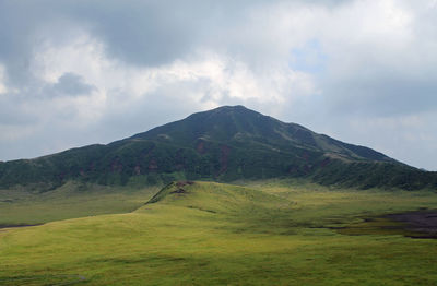 Scenic view of mountains against cloudy sky