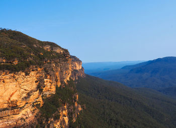 Scenic view of mountains against clear blue sky