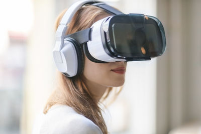 Woman wearing virtual reality glasses and headphones