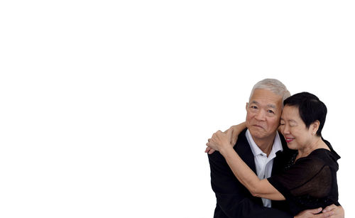 Couple standing against white background