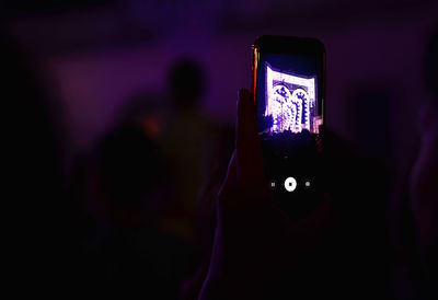 Close-up of person using smart phone at night