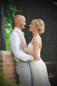 Side view of young couple looking each other face to face while standing outdoors