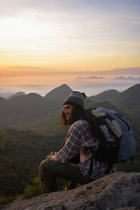 Man with backpack trekking in mountains. cumbiri hill, indonesia