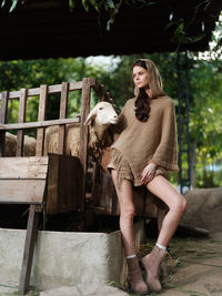 Side view of young woman standing in park