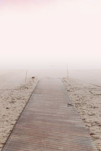 Surface level of sandy beach against sky