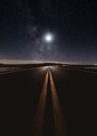 Road against sky at night