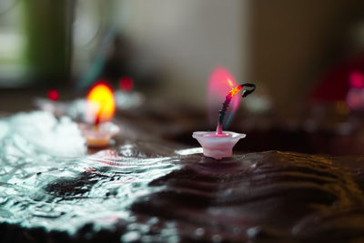 Close-up of lit candles in temple