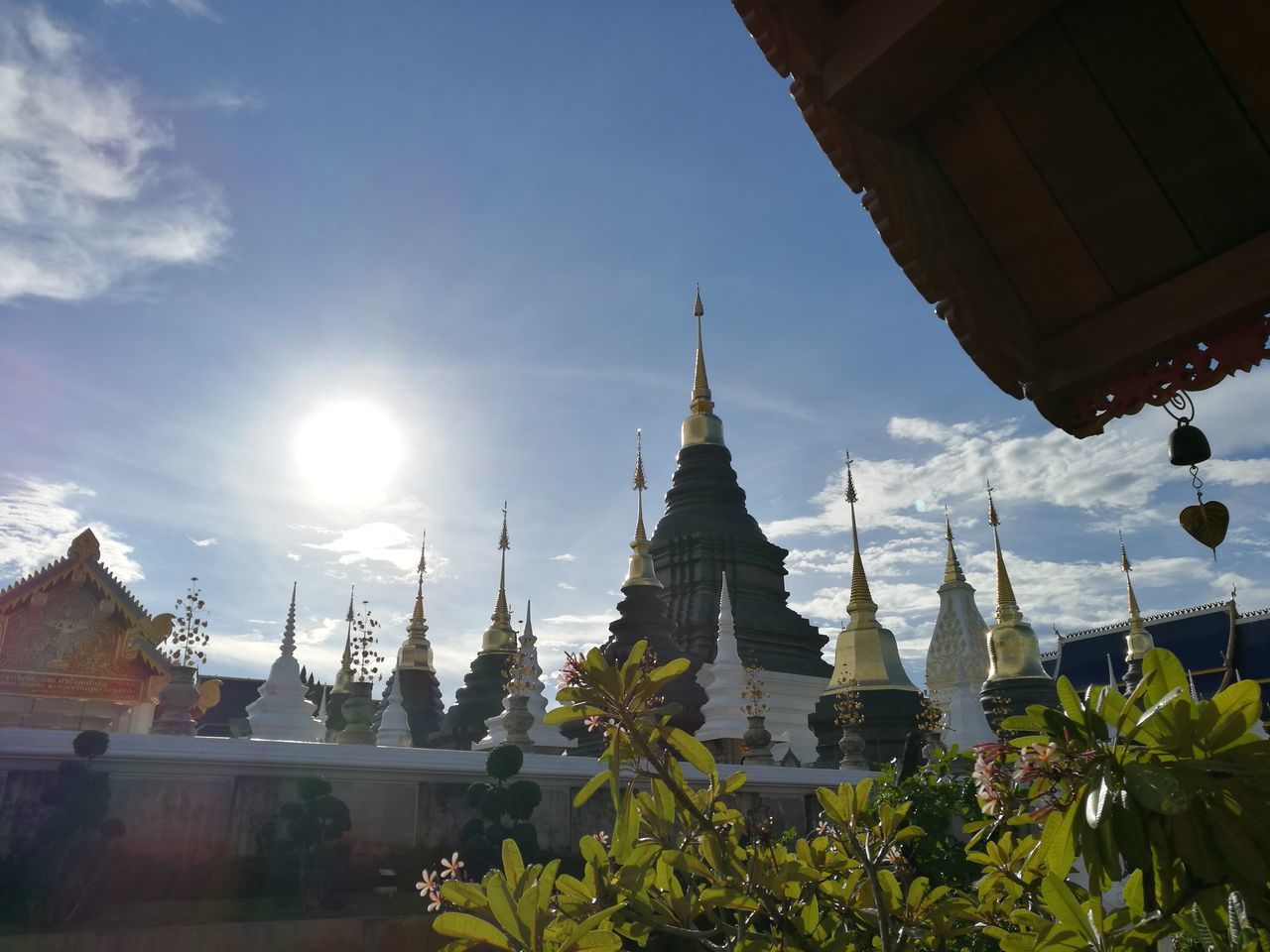 architecture, building exterior, built structure, place of worship, religion, spirituality, sky, church, sun, sunlight, sunbeam, dome, low angle view, cathedral, temple - building, famous place, tree, city