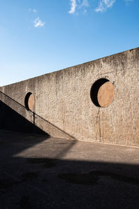 Concrete wall against blue sky