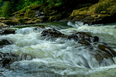 Stream flowing through rocks in sea