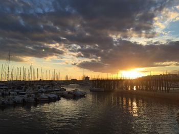 Scenic view of sea against cloudy sky at sunset