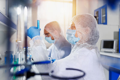 Side view of doctor examining patient in laboratory