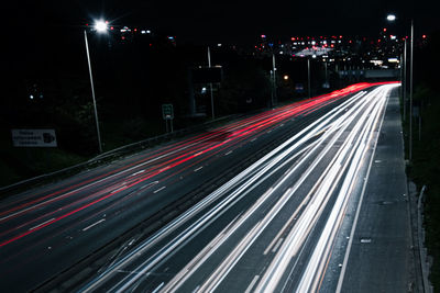 High angle view of light trails on road at night