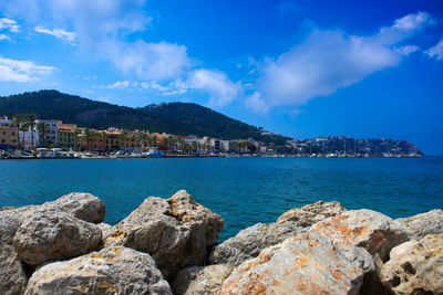 Scenic view of sea and buildings against sky