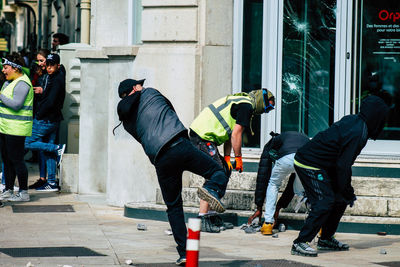 People photographing on street in city