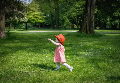 Portrait of a girl in a red belgian flag hat in the park.