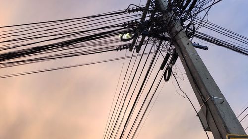 Low angle view of electricity pylon against sky