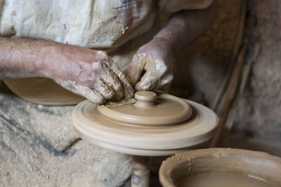 Man working on pottery wheel