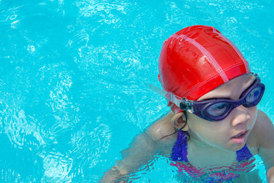 Portrait of boy swimming in pool