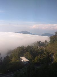 Scenic view of townscape by mountains against sky