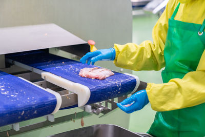 Midsection of man working on table