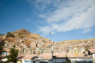 Town by mountain against sky