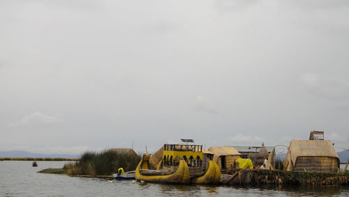 Boats in river against sky