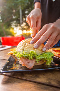 Midsection of person holding food on table