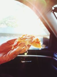 Close-up of hand holding ice cream cone