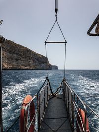 Sailboat on sea against clear sky