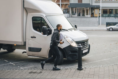 Full length of man on street in city