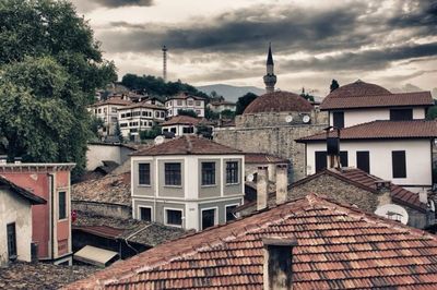 Residential buildings against cloudy sky