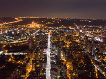 High angle view of illuminated city buildings at night