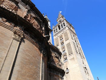 Low angle view of historical building against clear blue sky